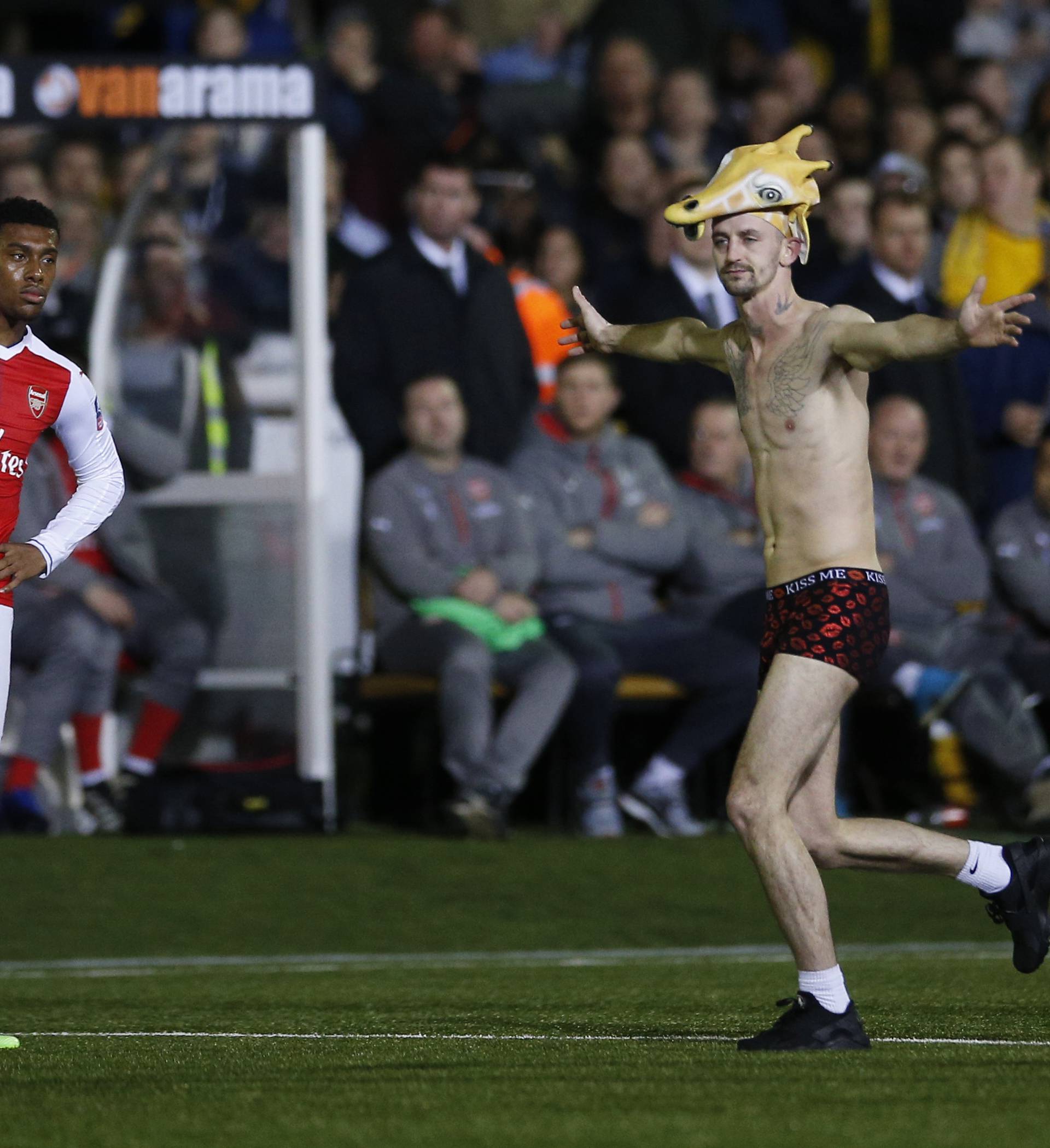 A streaker on the pitch as Arsenal's Alex Iwobi looks on
