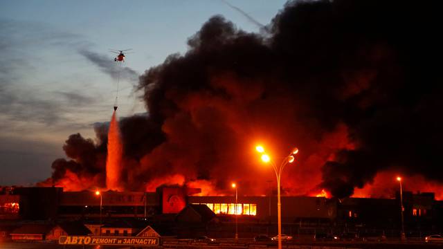 A helicopter dumps water on a fire at a construction goods market on the northwestern edge of  Moscow