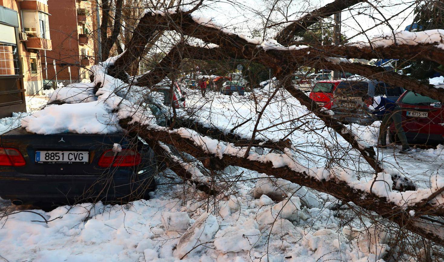 A man cleans icy street after a heavy snowfall in Madrid