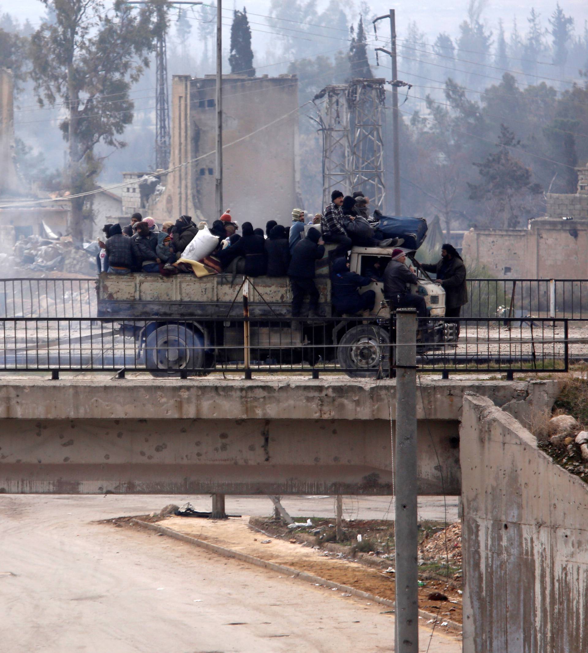 Evacuees from rebel-held eastern Aleppo ride on pick-up along the government-held area of al-Ramousah bridge