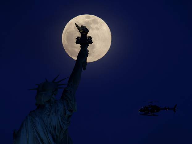 Pink Supermoon Over the Statue Of Liberty in New York