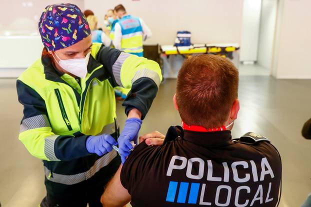 FILE PHOTO: A police officer receives his first dose of the AstraZeneca COVID-19 vaccine in Madrid