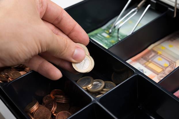 Close-up,Of,Person,Hands,Putting,Coins,In,Cash,Register