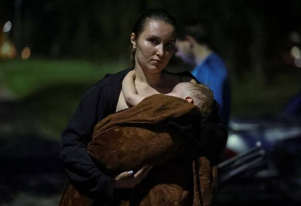 People take shelter inside a metro station during a Russian drone and missile strike in Kyiv