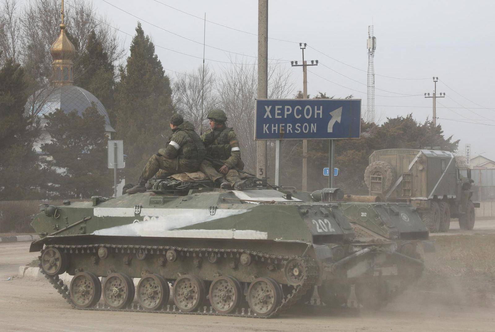 An armoured vehicle drives along a street in Armyansk