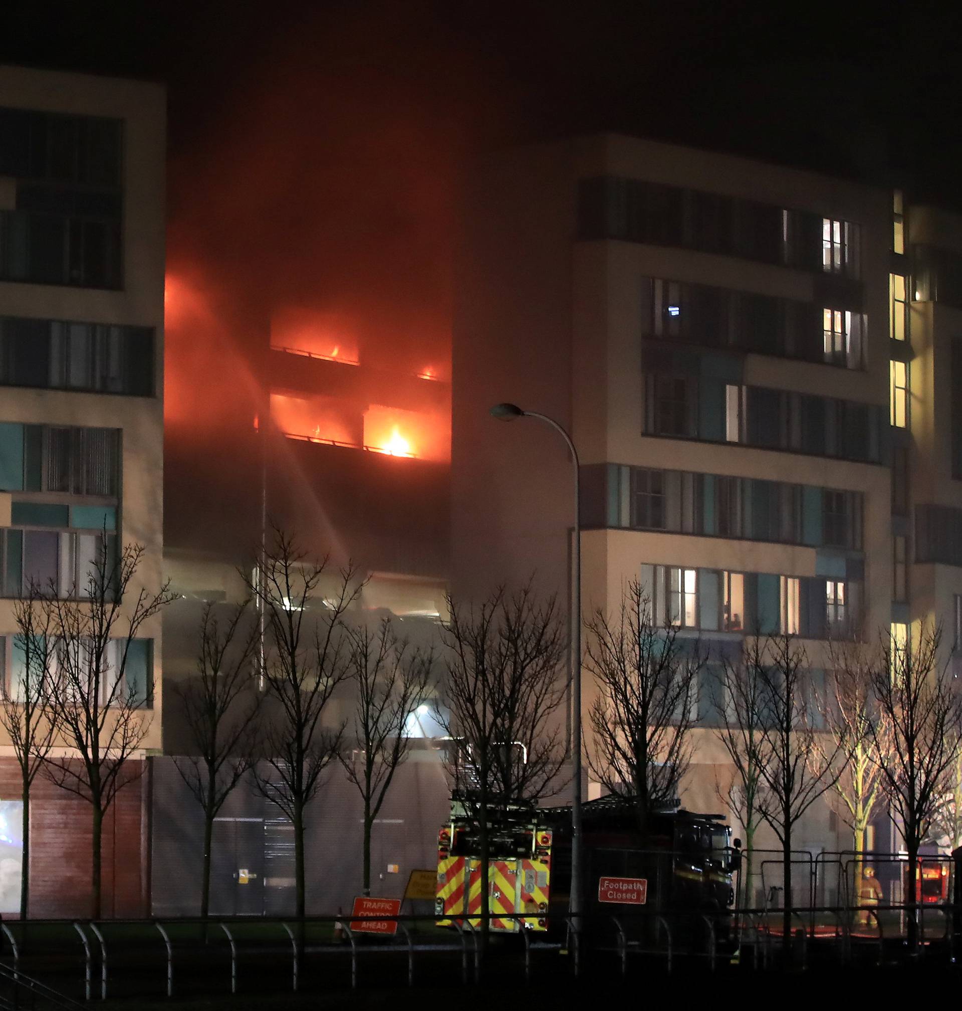 Firefighters tackle a fire during a serious blaze in a multi-storey car park in Liverpool, Britain.