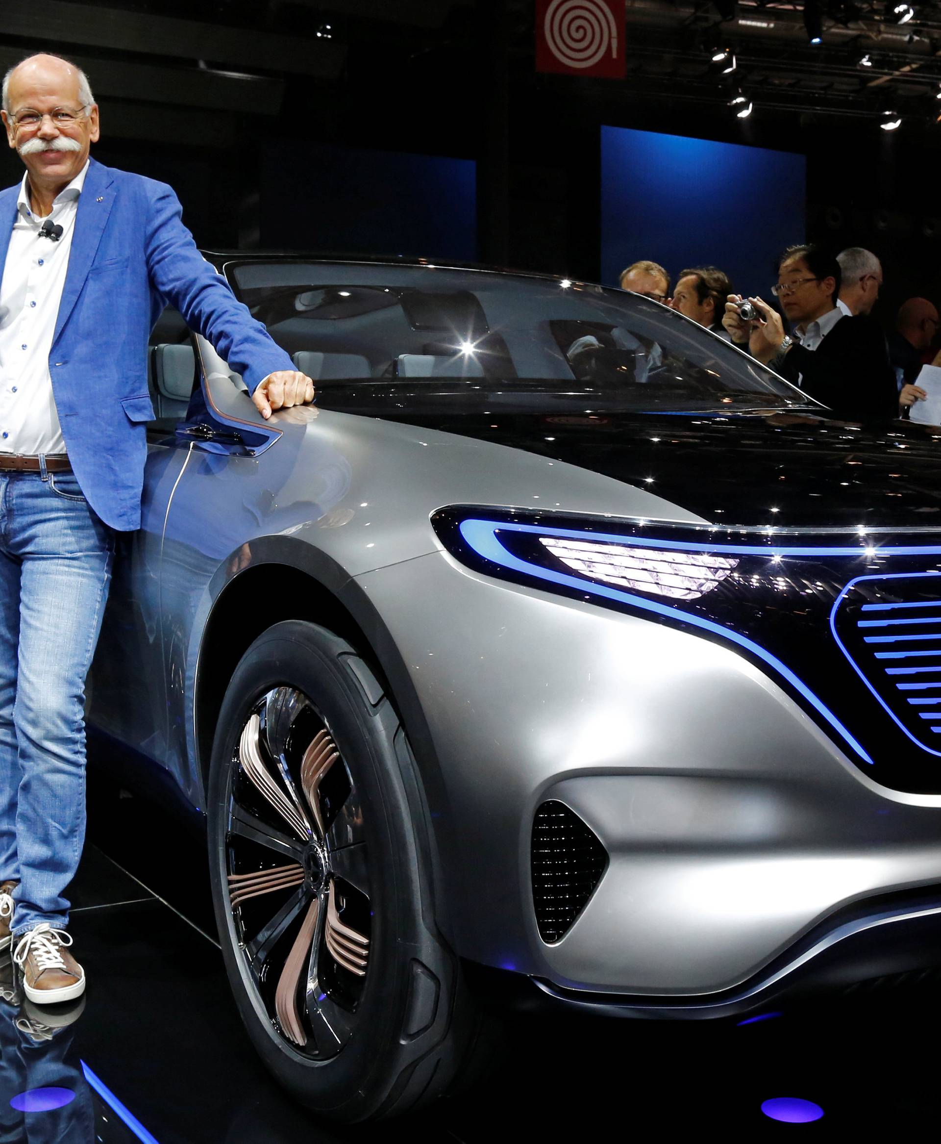 Dieter Zetsche, CEO of Daimler and Head of Mercedes-Benz, poses in front of a Mercedes EQ Electric car on media day at the Mondial de l'Automobile in Paris