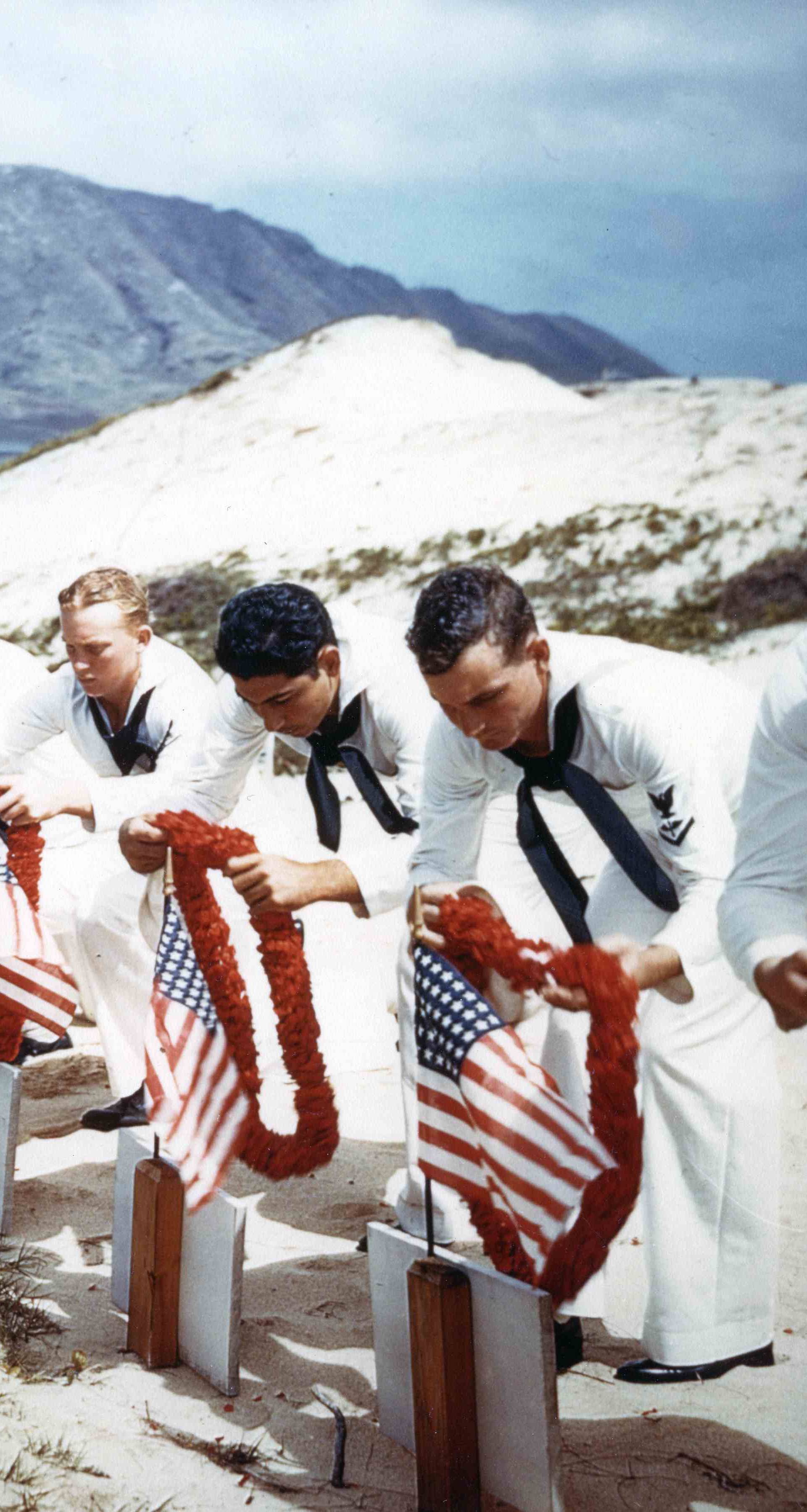 Archive photo of Sailors honoring men killed during the Japanese Pearl Harbor attack the previous year on Naval Air Station Kaneohe