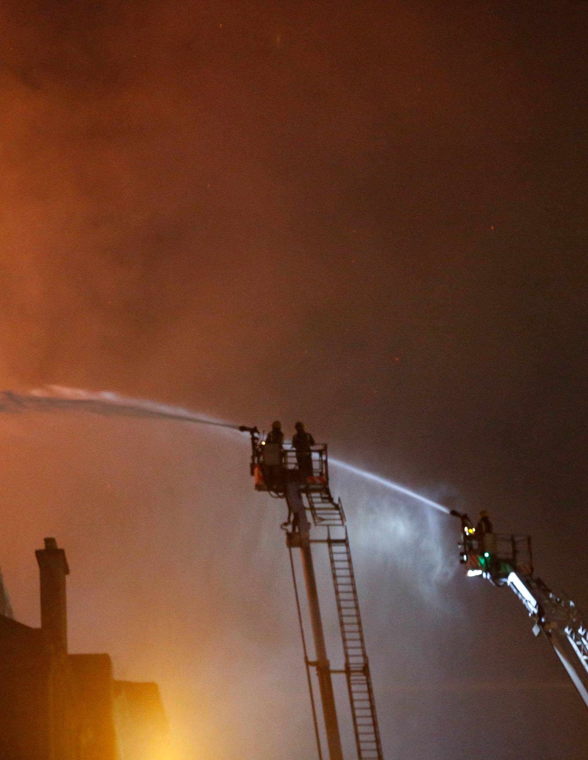 Firefighters attend to a blaze at the Mackintosh Building at the Glasgow School of Art, which is the second time in four years, Glasgow, Scotland, Britain