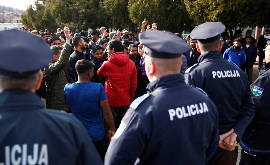 Migrants are stoped by police while trying to block road in front of the refugee camp Miral in Velika Kladusa