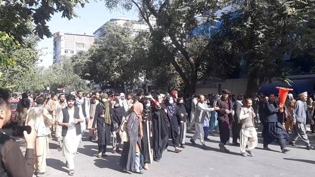 FILE PHOTO: People march in protest near the Central Kabul Bank, in Kabul