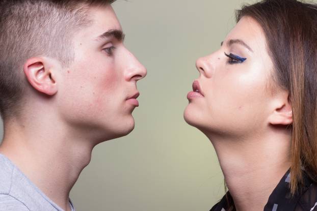 Young adult man woman girl boy looking at each other close by