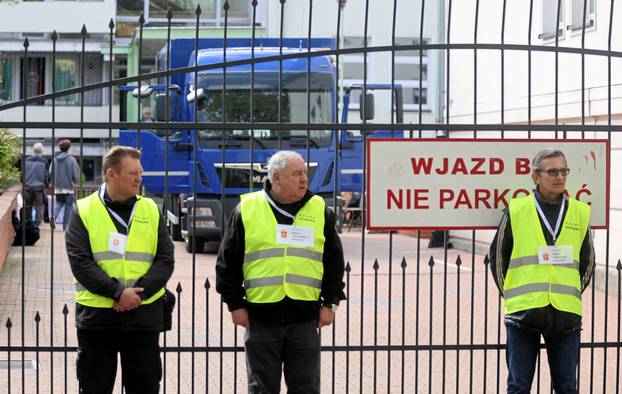 People leave the building of Russian embassy school in Warsaw