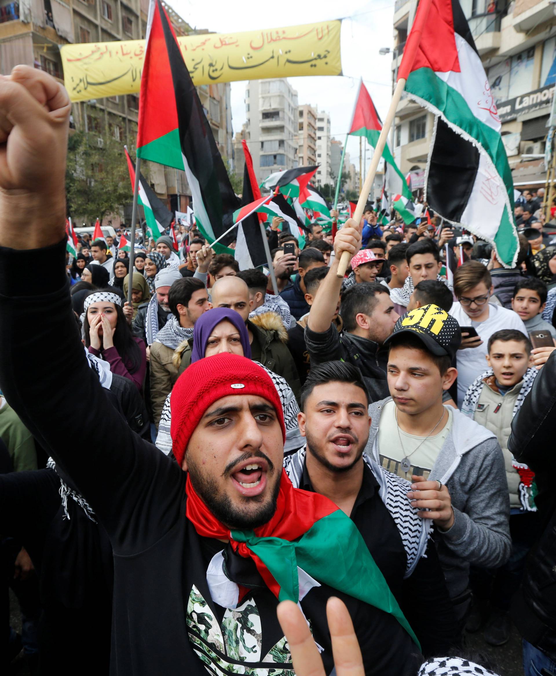 Protestors chant slogans and hold Palestinian flags in Beirut