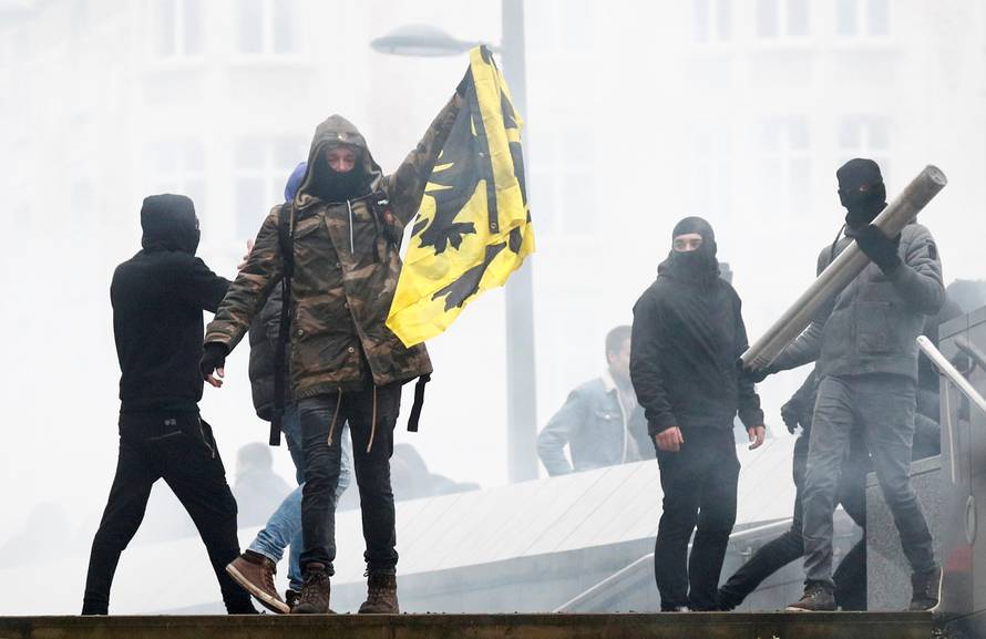 Flemish nationalist holds a Flemish flag as he attends a protest against Marrakesh Migration Pact in Brussels