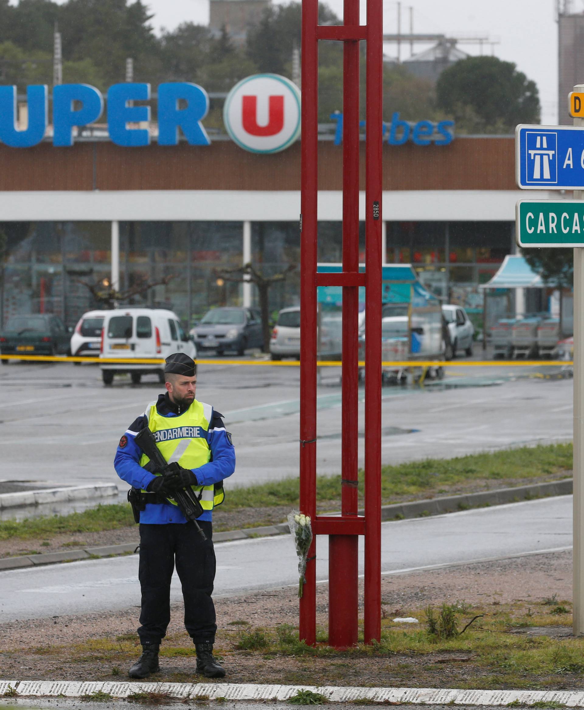 A French gendarme secures the access to a supermarket after a hostage situation in Trebes