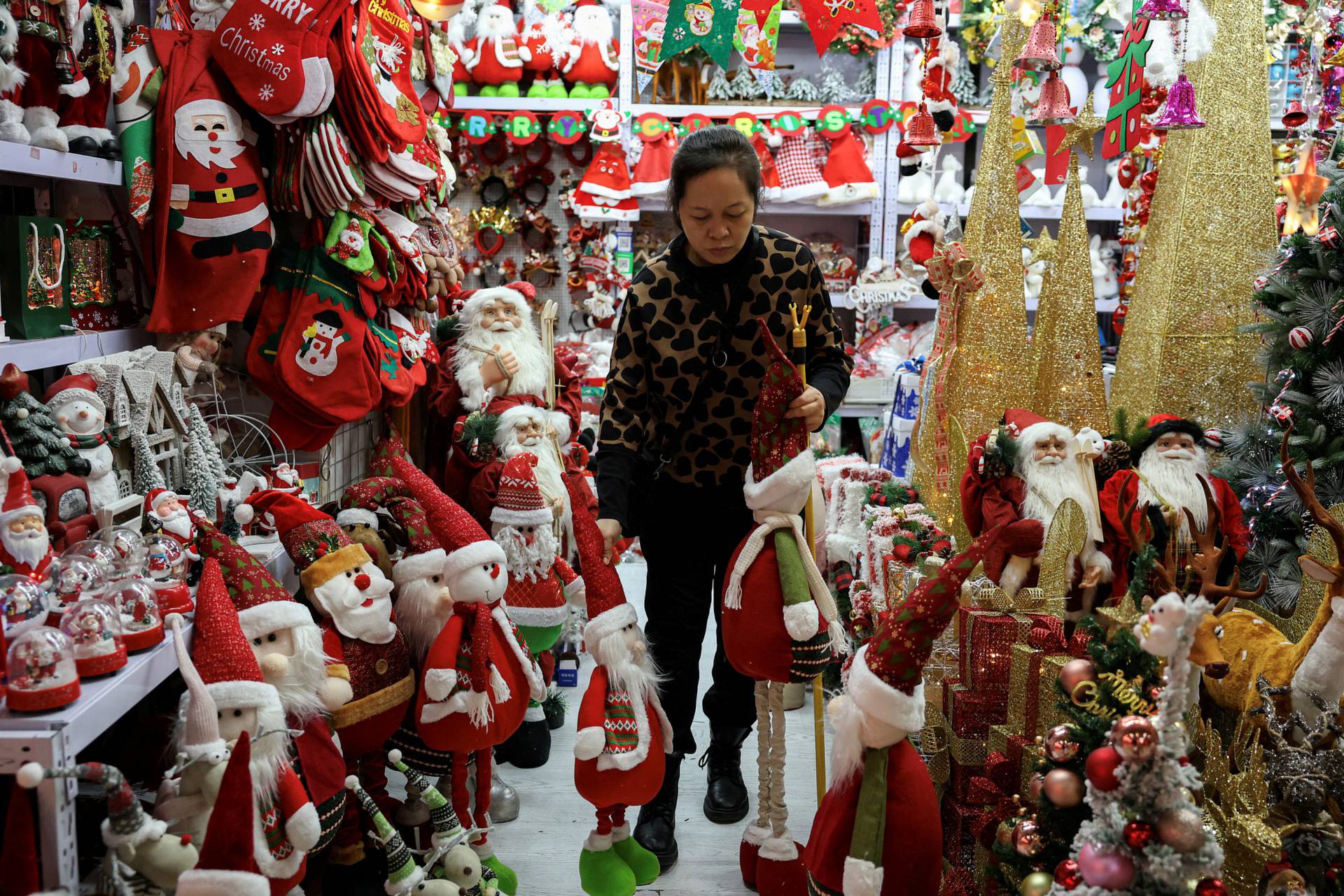 FILE PHOTO: A vendor sorts products at a booth selling Christmas decorations at a mall in Beijing