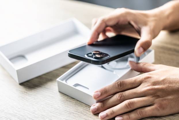 A,Customer,In,A,Smartphone,Store,Opens,A,Box,With