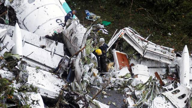 Rescue crew work in the wreckage from a plane that crashed into Colombian jungle with Brazilian soccer team Chapecoense near Medellin