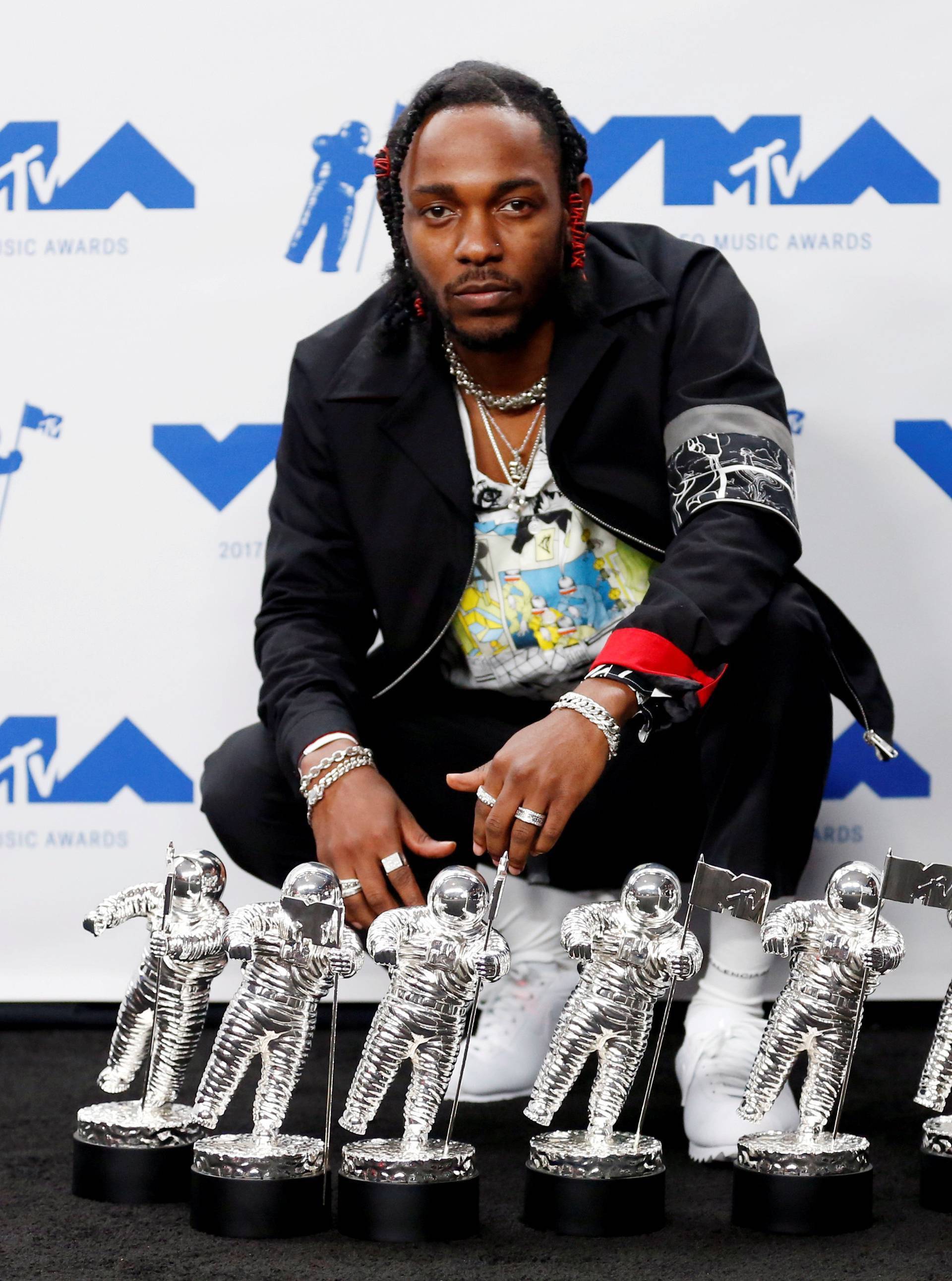 FILE PHOTO: Musician Kendrick Lamar poses for pictures with his awards at the 2017 MTV Video Music Awards in Inglewood