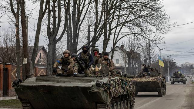 Ukrainian soldiers are seen on tanks, amid Russia's invasion of Ukraine, in Bucha