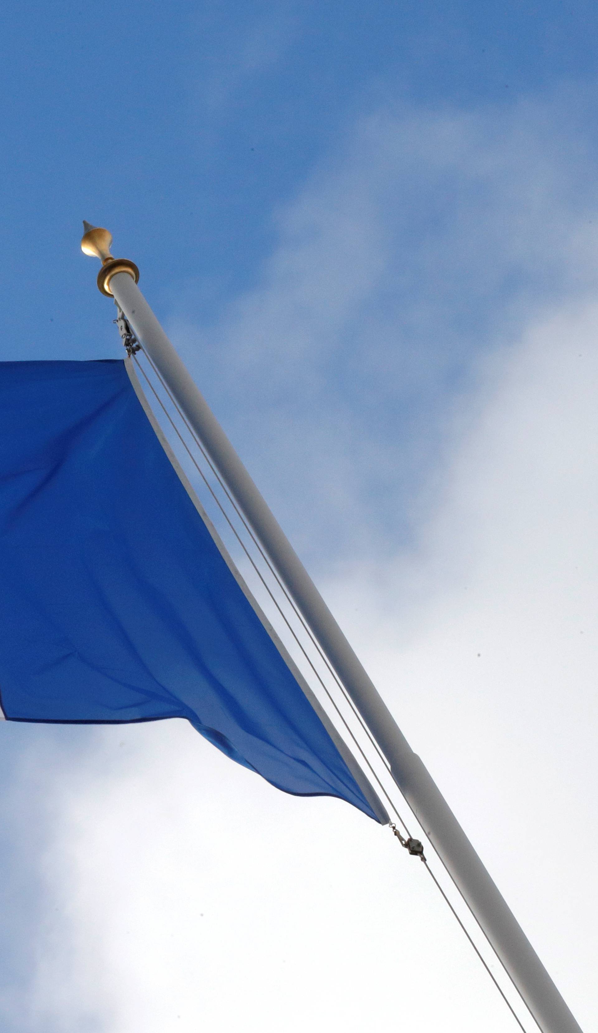 FILE PHOTO: A French flag flutters in the sky over the Elysee Palace in Paris