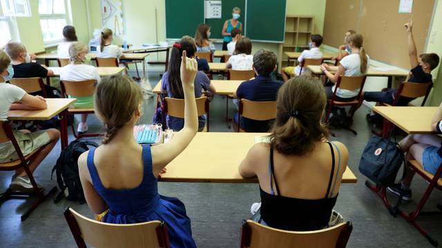 Pupils of the protestant high school "Zum Grauen Kloster" attend a lesson on the first day after the summer holidays in Berlin