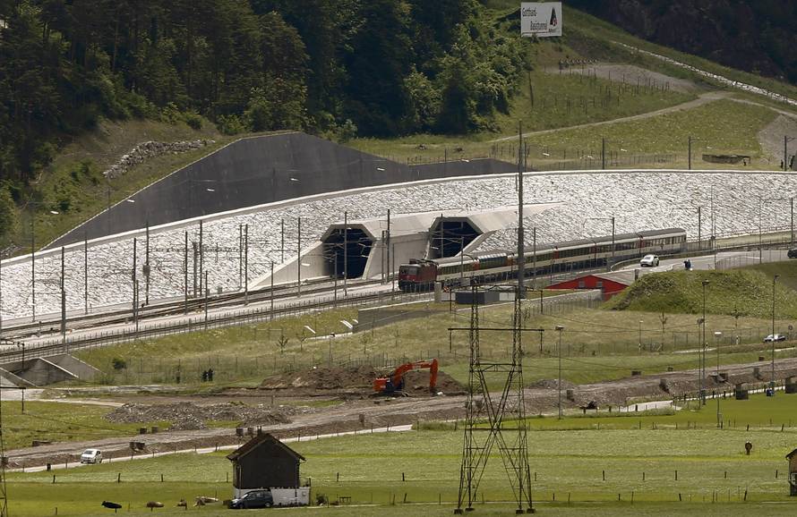 A train drives past the northern gates of the NEAT Gotthard Base Tunnel near Erstfeld