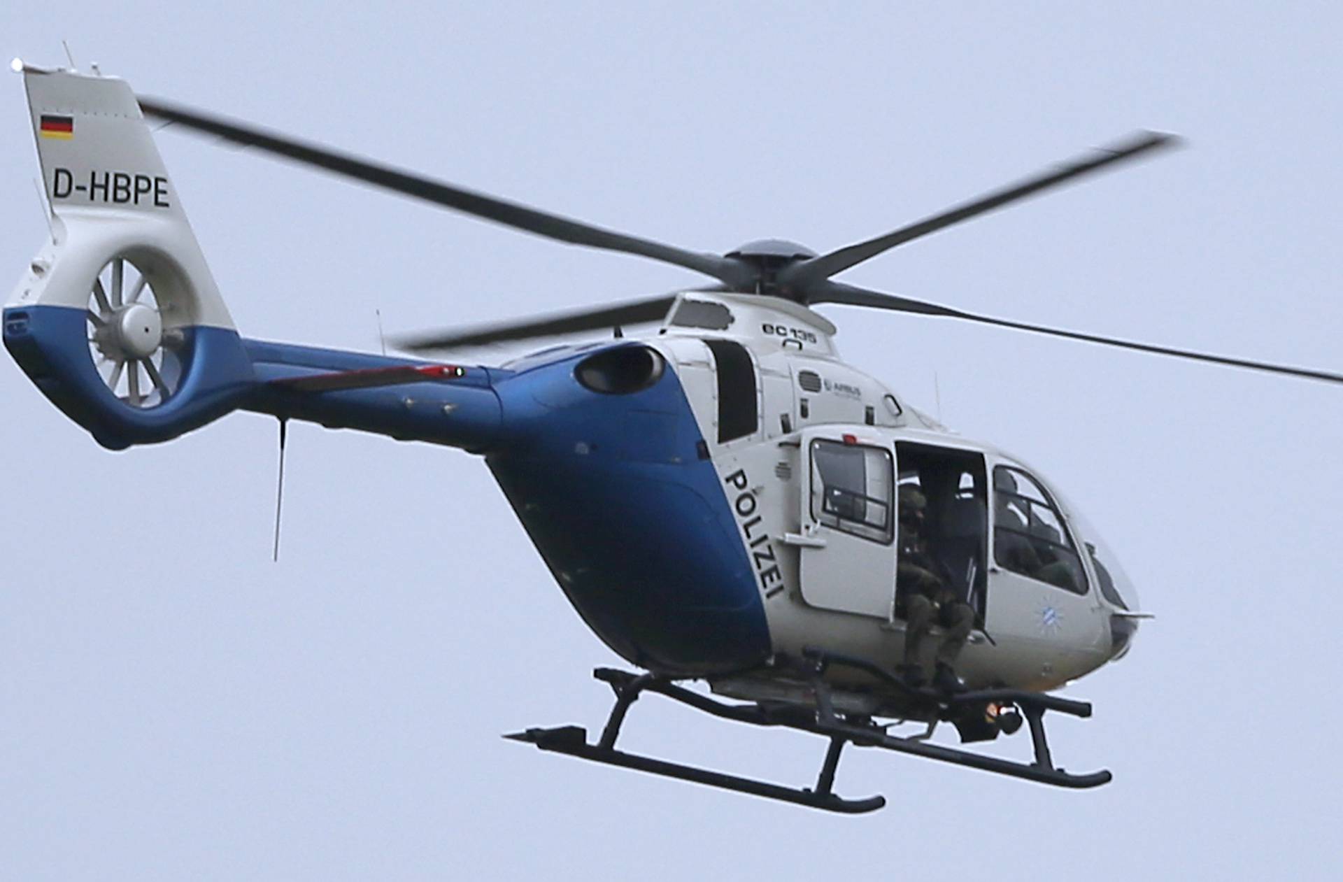 A police sniper sits in helicopter above scene of shooting rampage in Munich