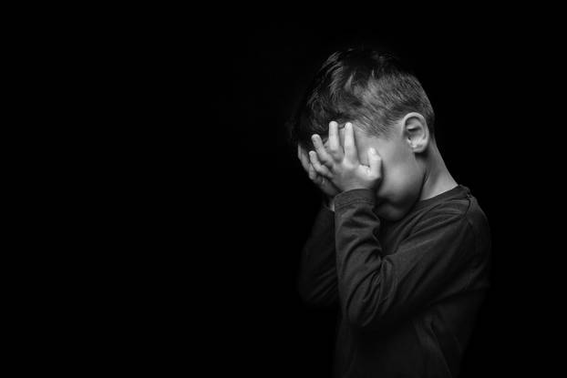 child whose depression is on a black background