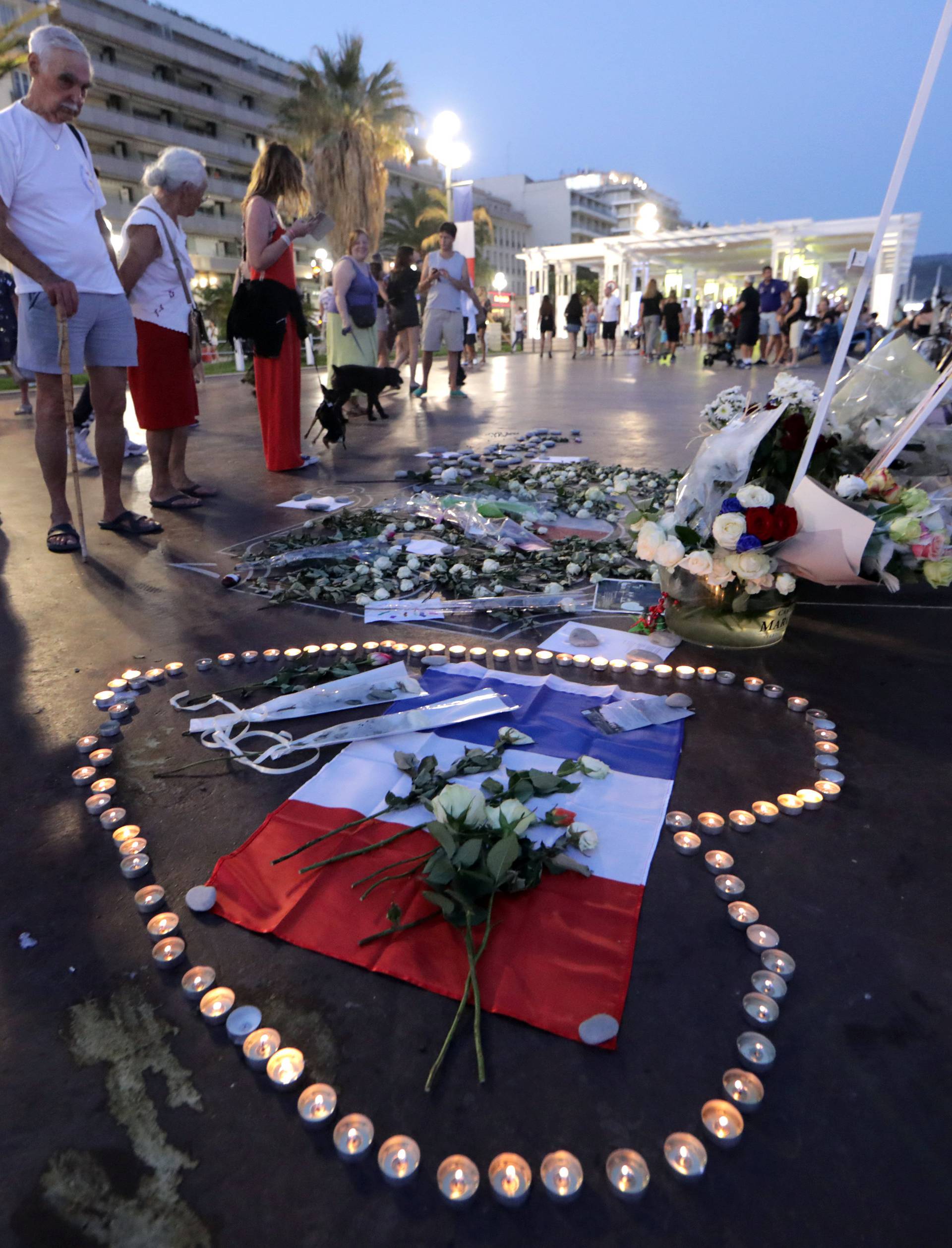 People look at a memorial on the Promenade des Anglais as part of the commemorations of last year's July 14 Bastille Day fatal truck attack in Nice