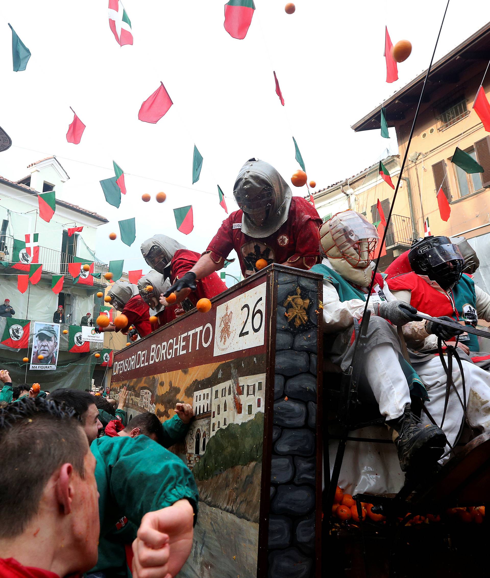 Members of rival teams fight with oranges during an annual carnival battle in the northern Italian town of Ivrea