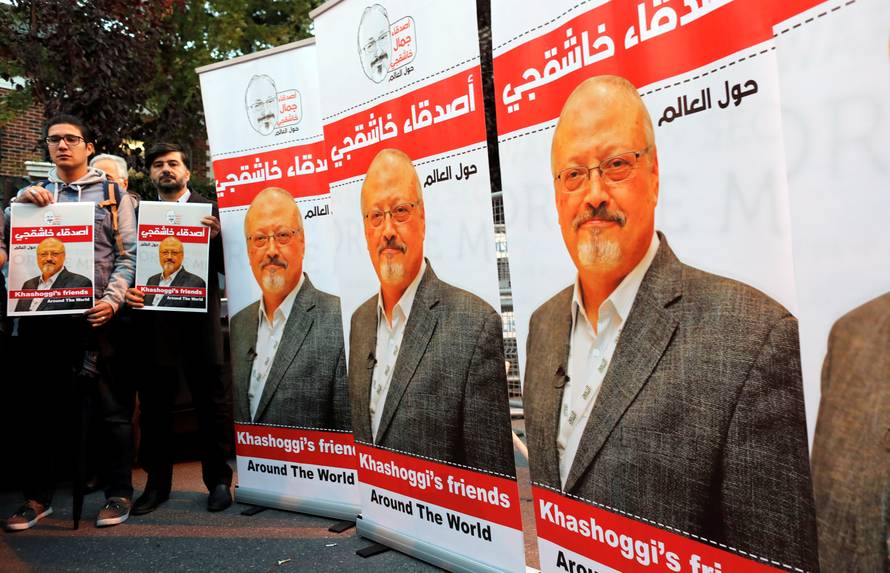 Friends of Saudi journalist Khashoggi hold posters and banners with his pictures during a demonstration outside the Saudi Arabia consulate in Istanbul