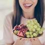 Cropped close-up portrait of her she nice attractive pretty charming cheerful cheery brown-haired single girl sitting on sofa licking lip eating tasty berries staying home apartment