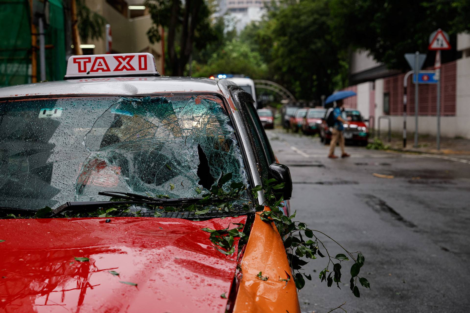 A taxi damaged by fallen trees is seen following Super Typhoon Saola in Hong Kong