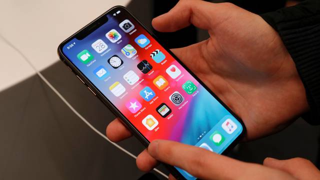 A customer tests a smartphone during the launch of the new iPhone XS and XS Max sales at a shop in Moscow