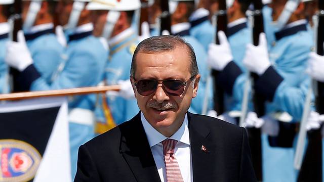 Turkish President Tayyip Erdogan reviews a guard of honour during a welcoming ceremony at the Presidential Palace in Ankara