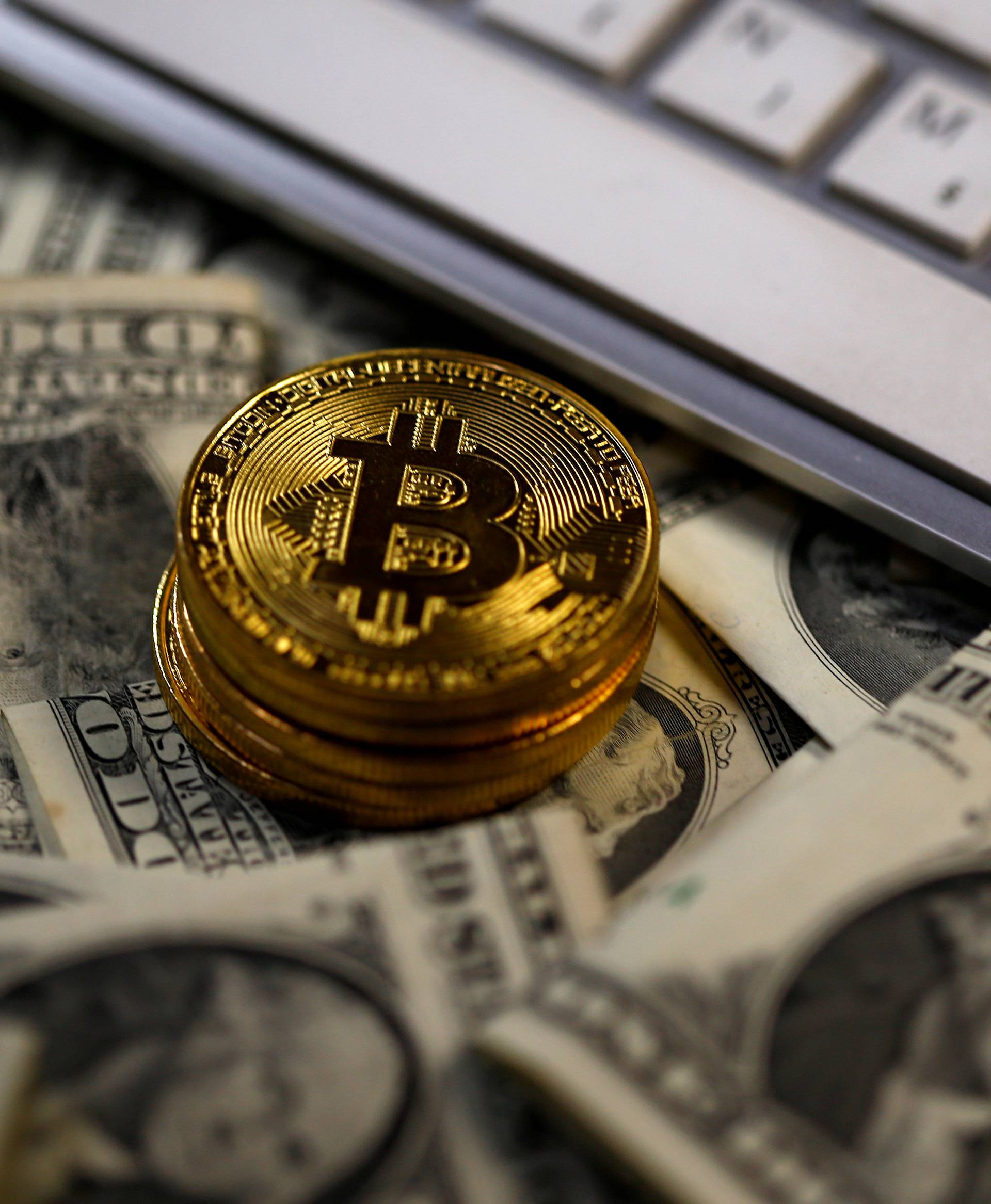 FILE PHOTO: Bitcoin (virtual currency) coins placed on Dollar banknotes are seen in this illustration picture