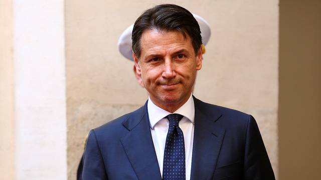 Italy's Prime Minister-designate Giuseppe Conte review the guard of honour at Chigi palace in Rome