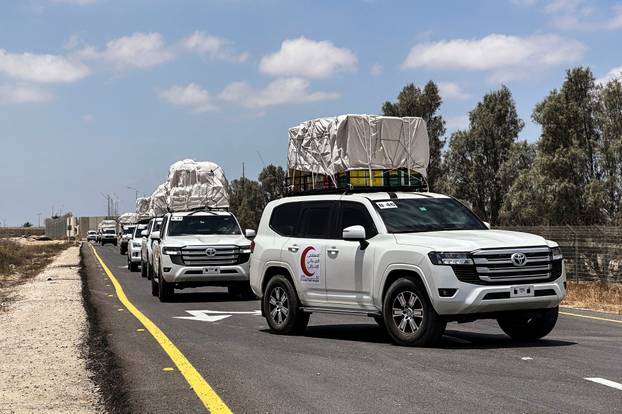 Vehicles loaded with goods enter the Kerem Shalom crossing between Israel and Gaza, on the Israeli side, on their way into Gaza