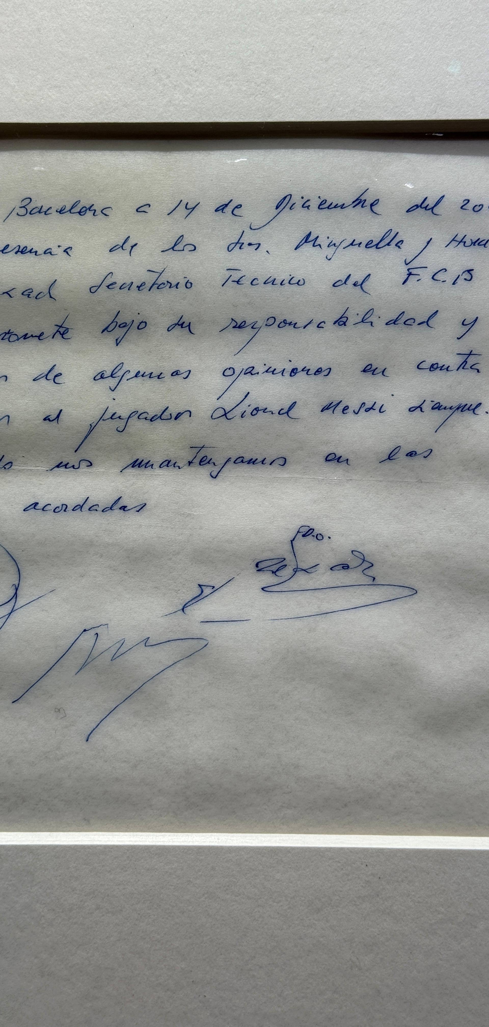 Signed and framed napkin on which soccer club Barcelona promised to sign a 13-year-old Lionel Messi is displayed at the Bonhams auction house in London