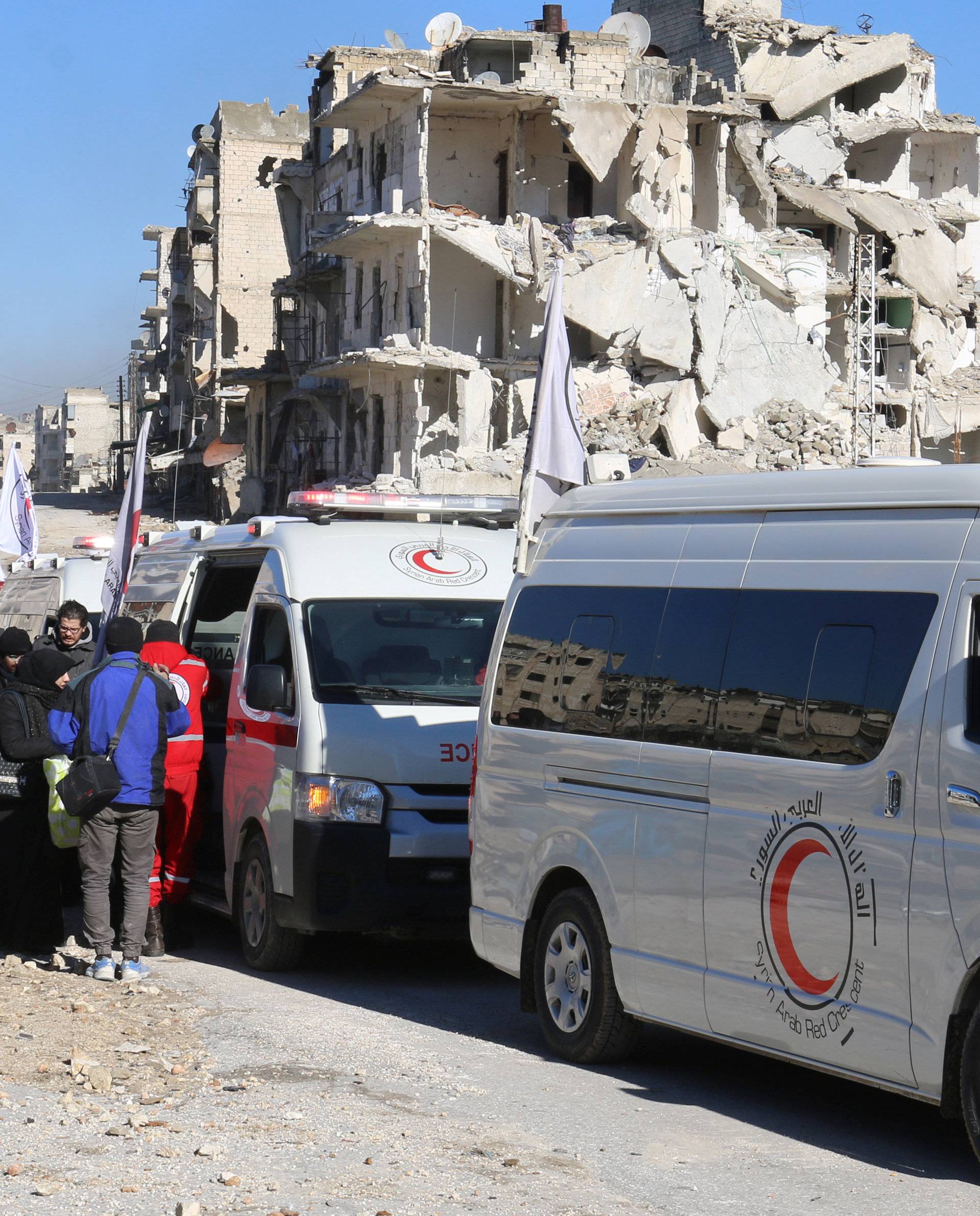 Ambulances wait as they evacuate people from al-Sukkari rebel-held sector of eastern Aleppo