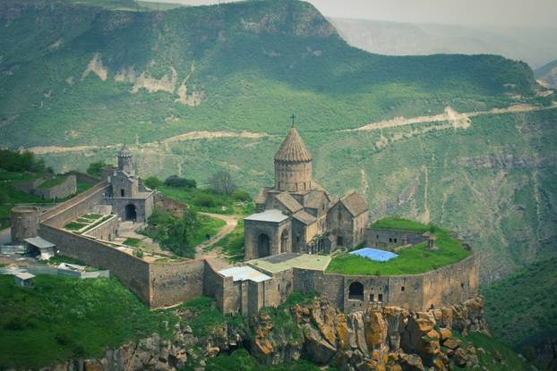 Ancient monastery in setting sun. Tatev. Armenia