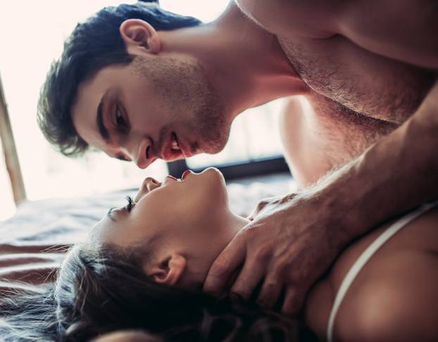 Couple having sex on bed