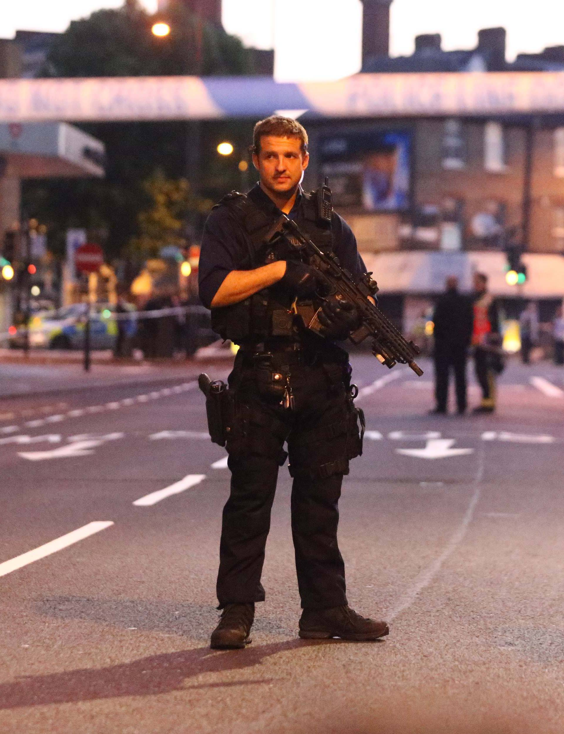 Police officers attend to the scene after a vehicle collided with pedestrians in the Finsbury Park neighborhood of North London