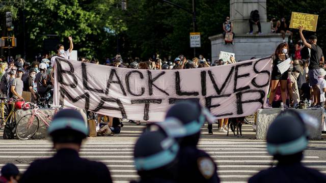 Demonstrators hold a Black Lives Matter banner during a protest against racial inequality in the aftermath of the death in Minneapolis police custody of George Floyd, at Grand Army Plaza in the Brooklyn borough of New York City