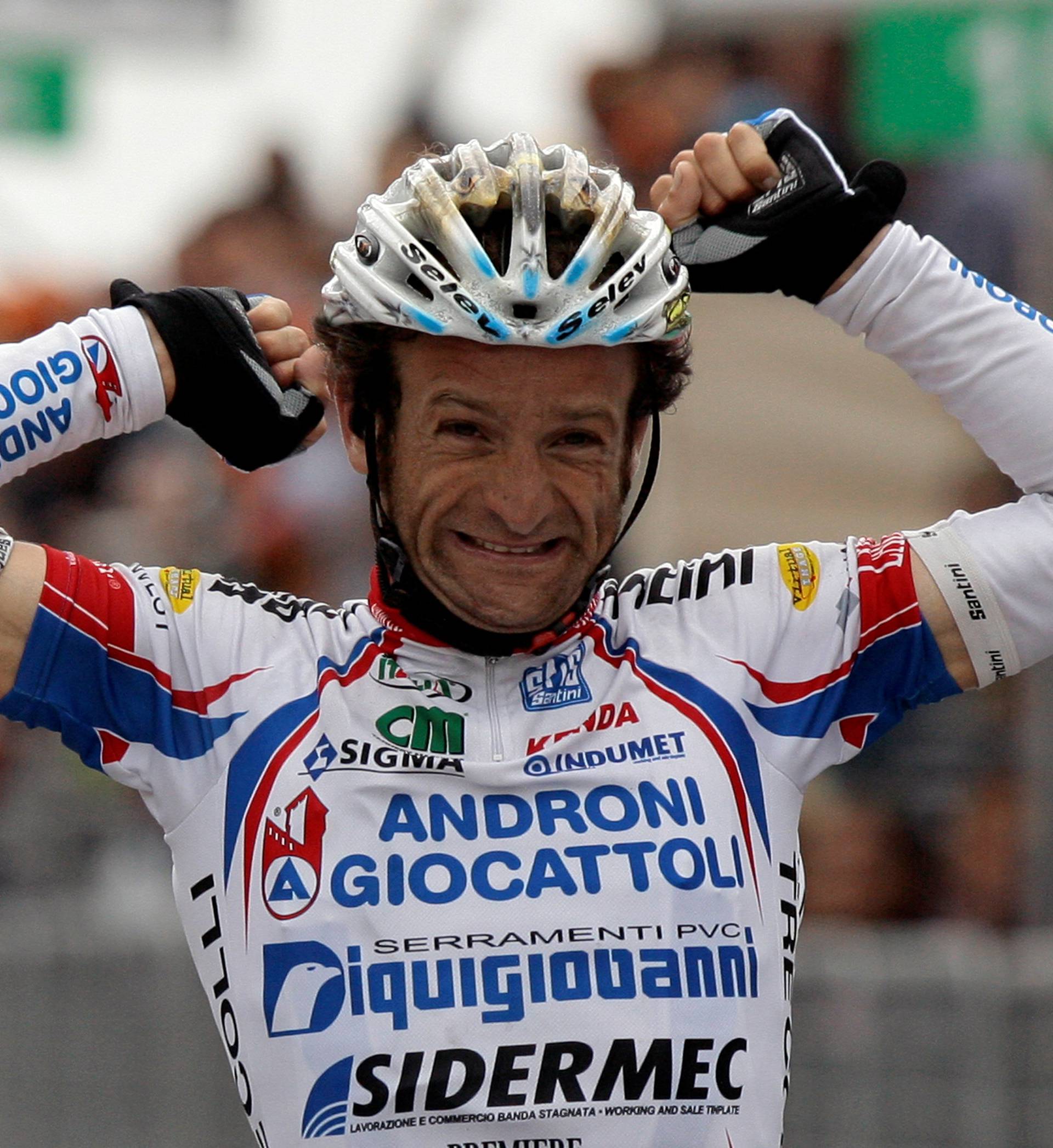 FILE PHOTO: Androni-Diquigiova team rider Scarponi celebrates his victory as he crosses the finish line of the 19th stage of the Giro d'Italia cycling race