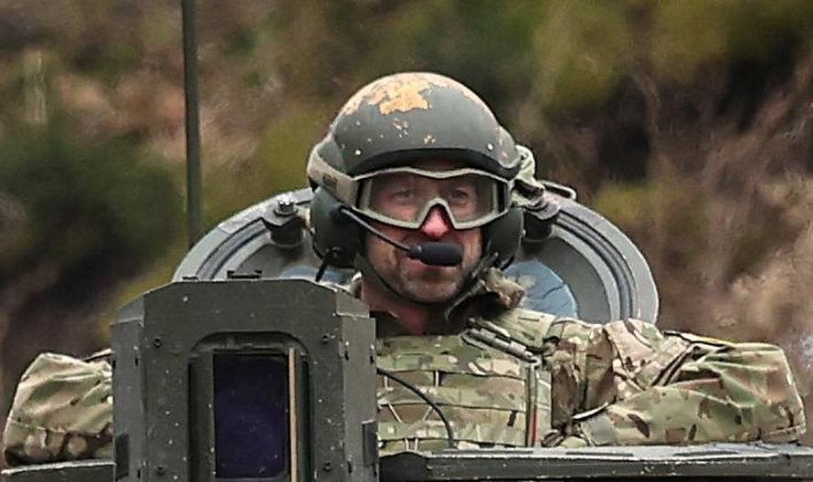 Britain's Prince William, Prince of Wales rides in a Challenger 2 tank in Estonia