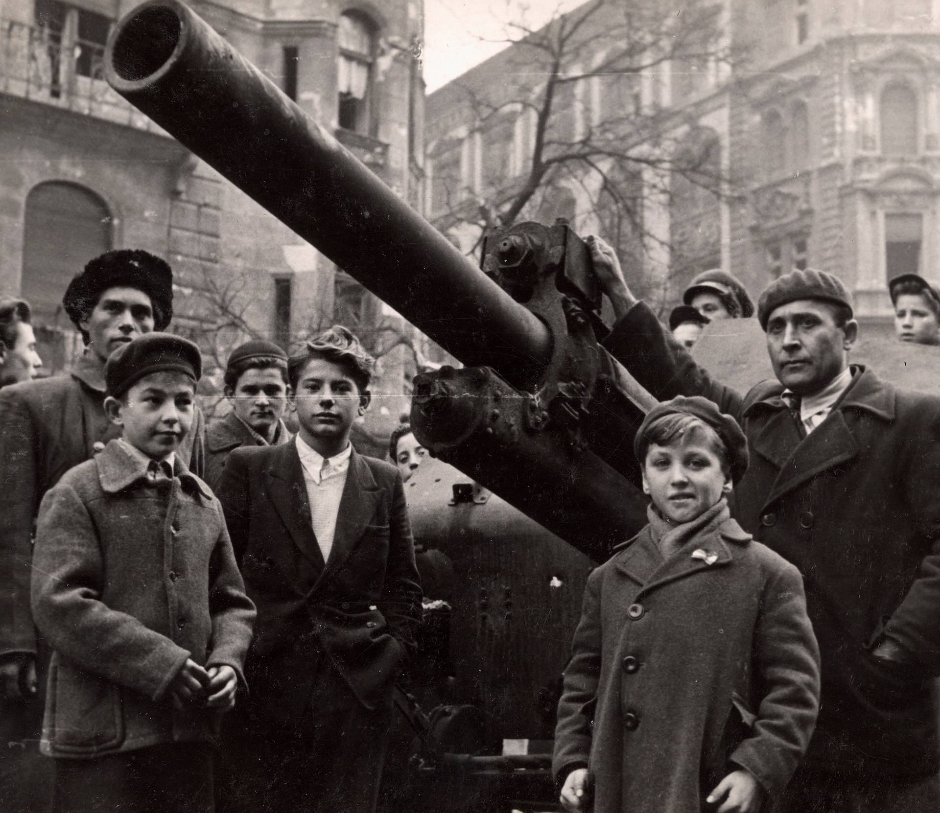 Fighters stand next to a Soviet tank on the streets of Budapest at the time of the uprising against the Soviet-supported Hungarian communist regime in 1956