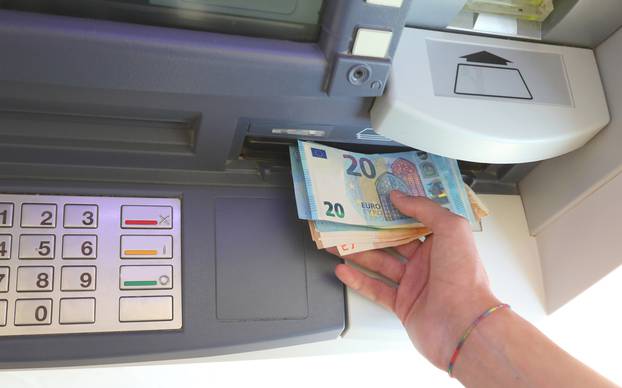Automatic,Atm,And,Banknotes,In,Euro,And,The,Hand